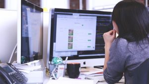 woman using a desktop computer
